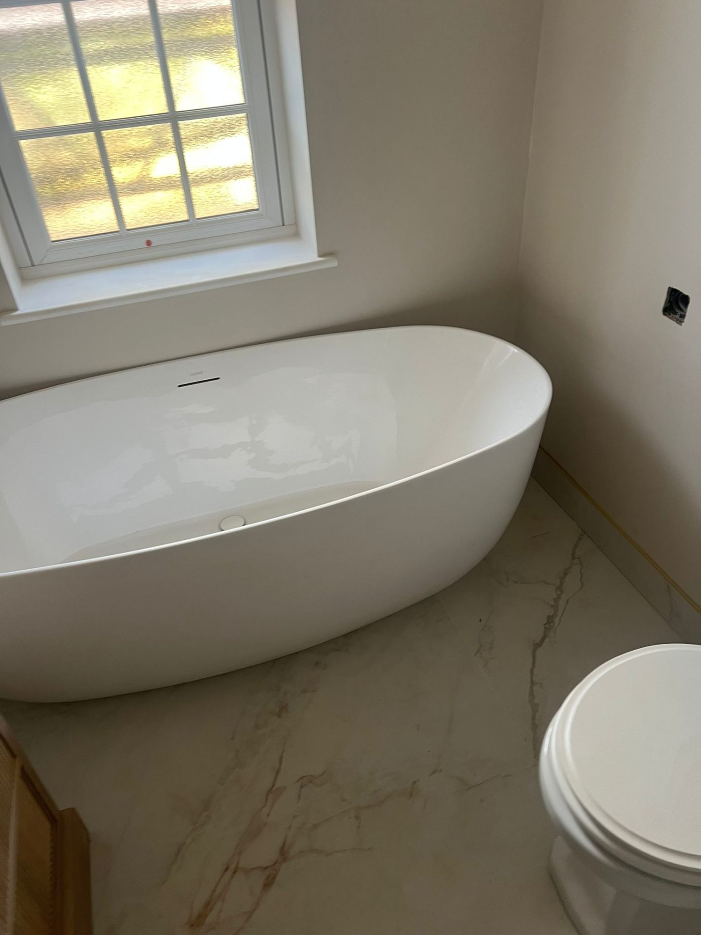 Freestanding bath on marble floor, luxury bathroom renovation, Essex