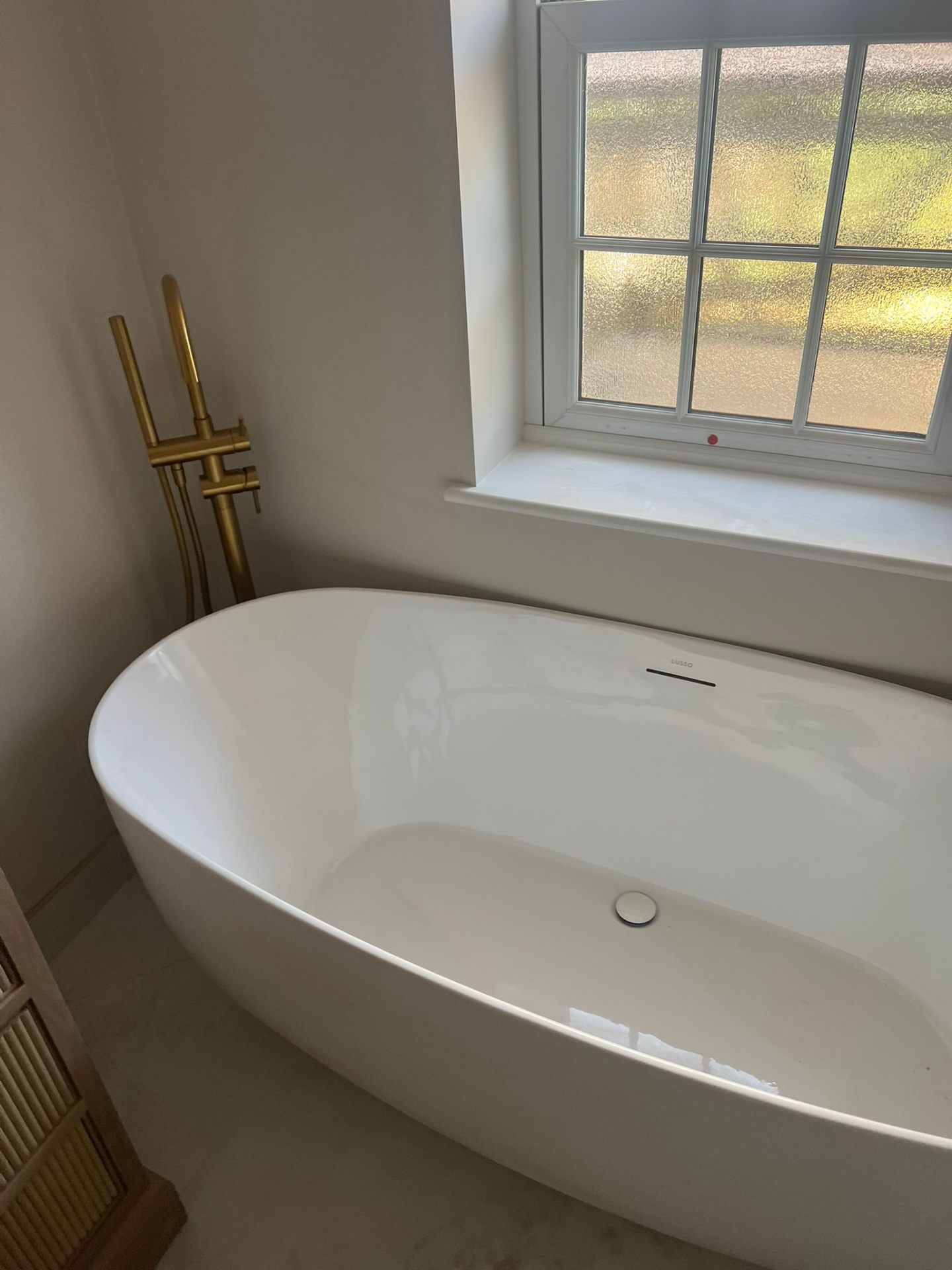Freestanding bath with brass floor-mounted taps, Essex