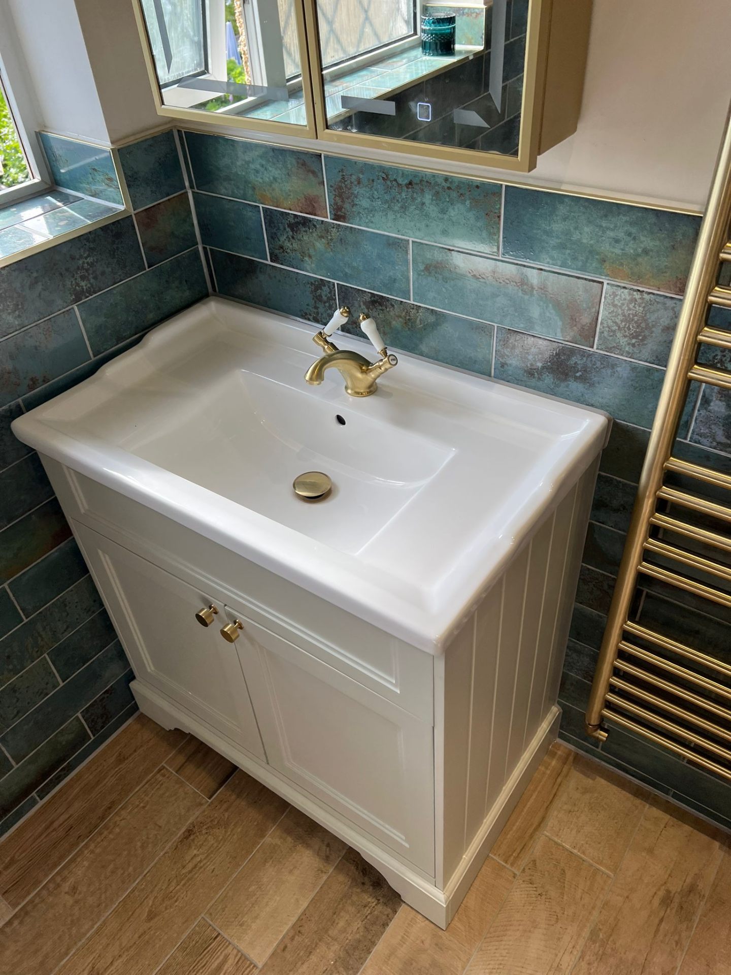 Bathroom vanity unit with brass taps and mirror cabinet, Essex
