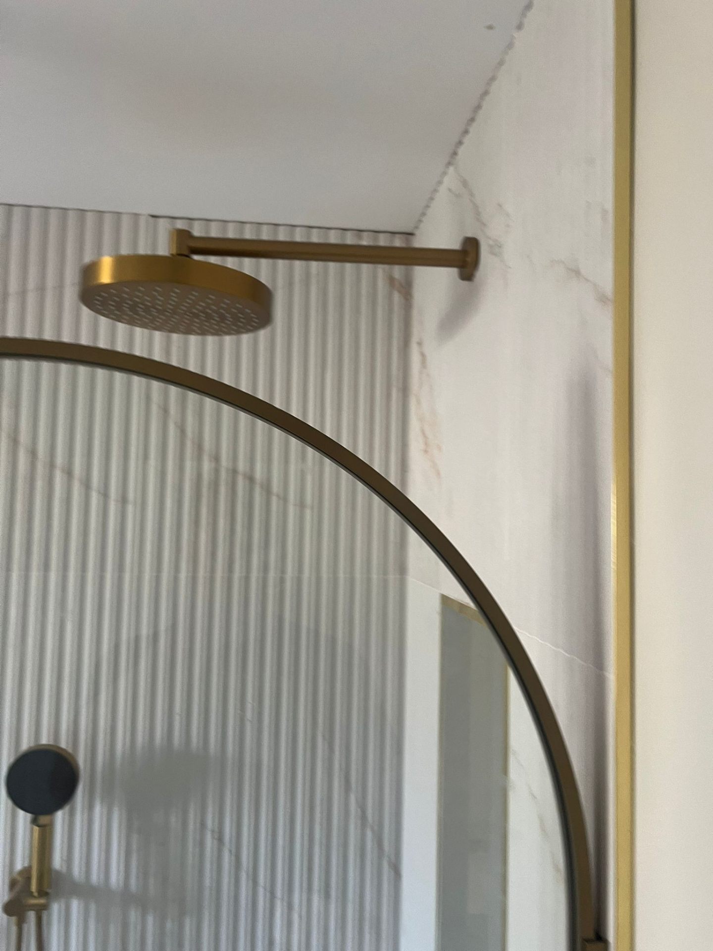 Luxury shower with brass rain head and marble tiles, Essex