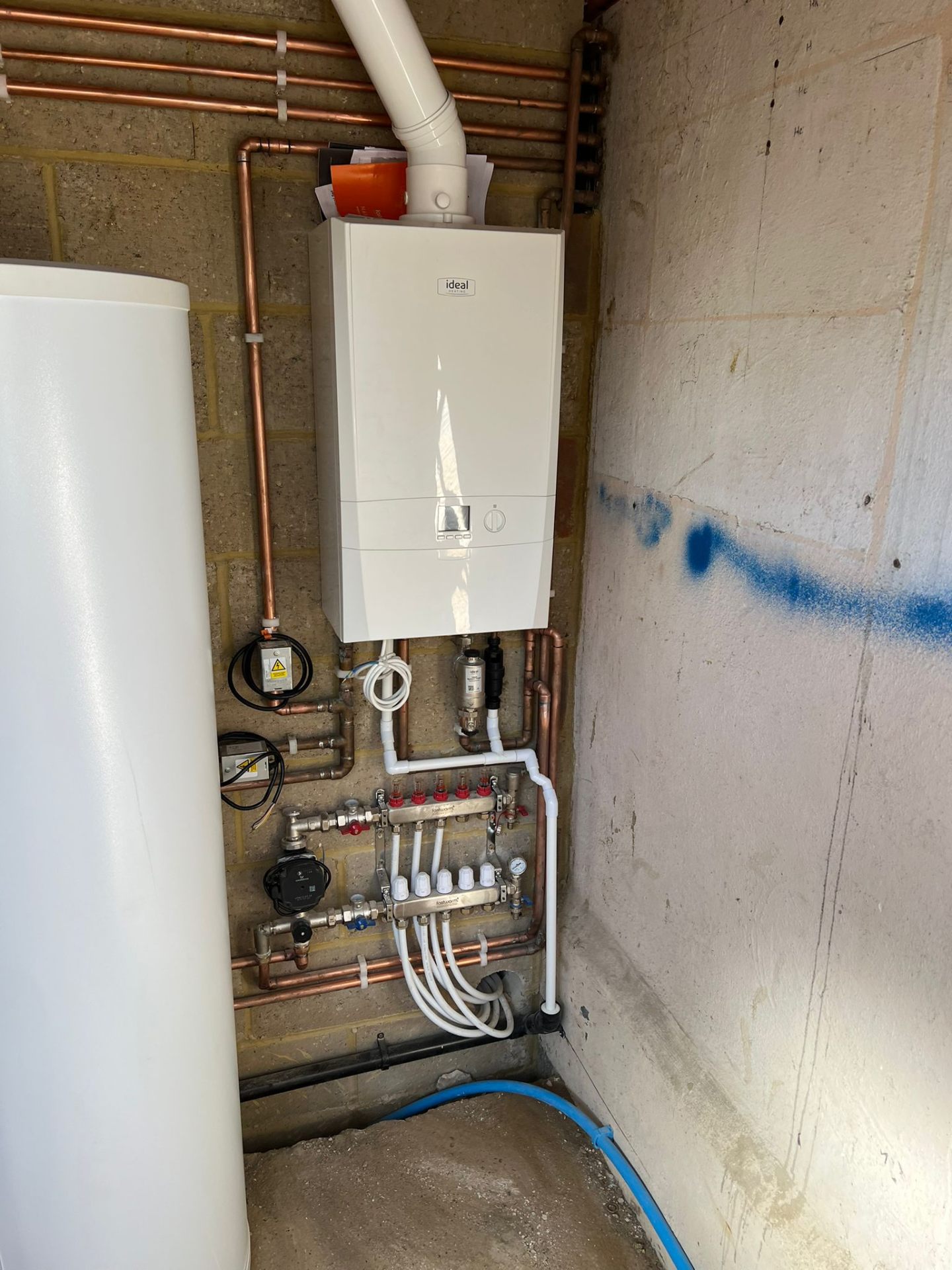 Ideal boiler installation feeding underfloor heating system, Essex
