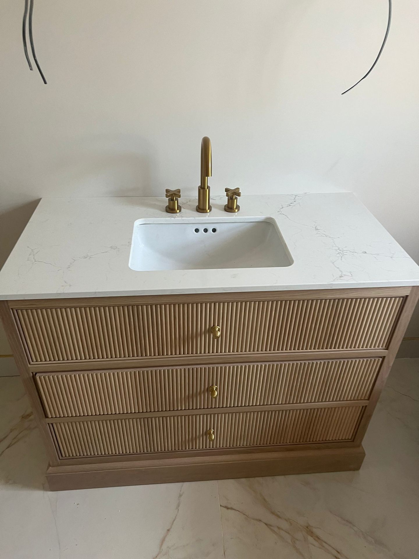 Bathroom vanity unit with quartz worktop and brass taps, Essex