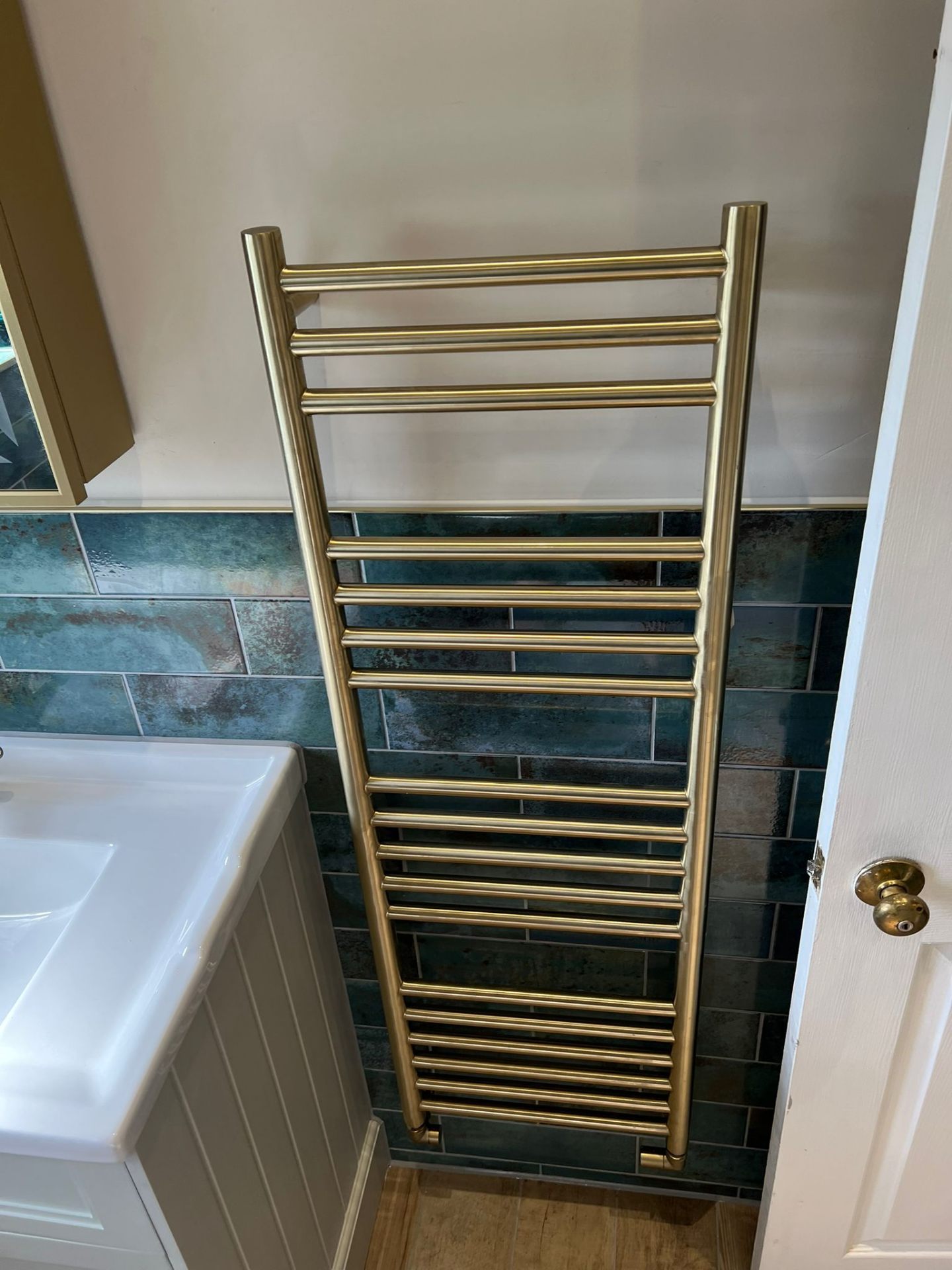 Heated towel rail in brass finish, Essex bathroom